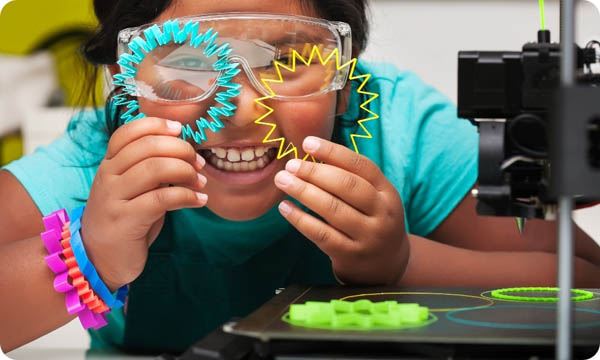Happy STEM Student Smiles and Shows off the Colorful 3D Printed Shapes