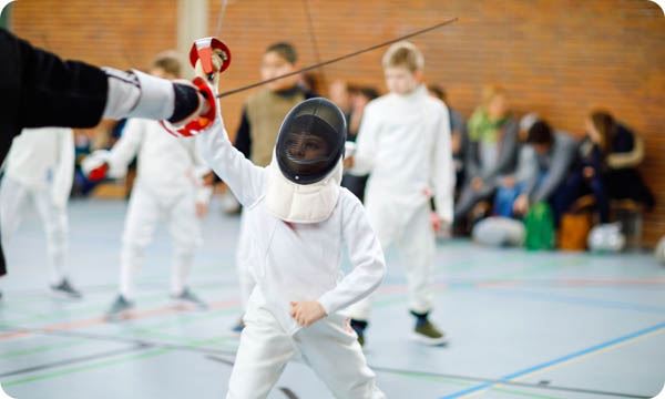 Little Kid Boy Fencing in a Fence Competition