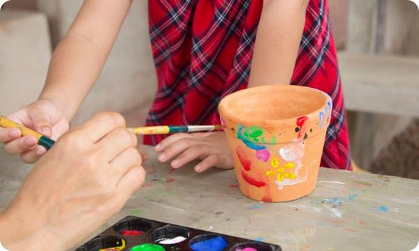 Child Paints Flower Pot