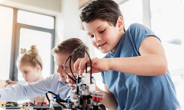 young boy working on a small machine
