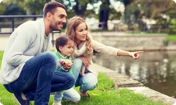 Happy Family Walking in Summer Park
