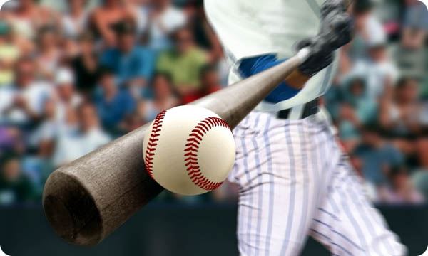 Baseball Player Hitting Ball with Bat in Close up
