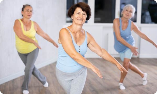 Group of Elderly Athletic Women Doing Dancing in Fitness Room