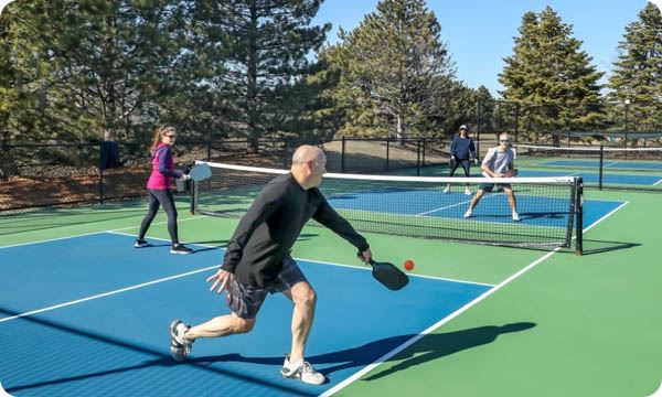 Men and Women in a Doubles Game of Pickleball