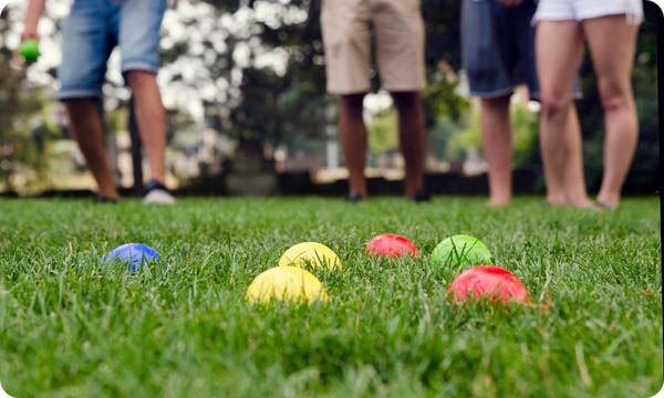 People Playing with Bocce Balls in Park