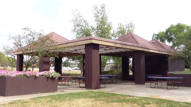 A picnic shelter with picnic tables in a city park